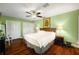 Spacious main bedroom featuring hardwood floors, a ceiling fan, and ample closet space at 2796 St Andrews Blvd, Tarpon Springs, FL 34688