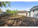 The back yard features a lawn, a chain link fence, and mature trees at 2930 W Arch St, Tampa, FL 33607
