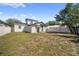 The back yard features a lawn, a privacy fence, and mature trees at 2930 W Arch St, Tampa, FL 33607