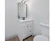Modern bathroom featuring a vanity with a sleek black mirror, contemporary lighting, and tiled floors at 2930 W Arch St, Tampa, FL 33607