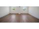 Empty bedroom with hardwood flooring and two windows at 2930 W Arch St, Tampa, FL 33607