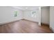 This bedroom features wood-look floors, bright natural light, and neutral paint at 2930 W Arch St, Tampa, FL 33607