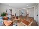 Inviting living room with wood floors, modern furnishings and art, with an open layout to the dining area at 2930 W Arch St, Tampa, FL 33607