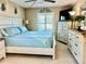 Bedroom featuring a blue bed, white dressers, a ceiling fan, and natural light from the window at 3161 Lake Pine S Way # H1, Tarpon Springs, FL 34688