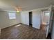 This bright bedroom features wood floors, a ceiling fan, a window, and a closet at 3239 Jarvis St, Holiday, FL 34690