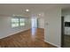 Open living room with hardwood floors and natural light, with kitchen in view at 3239 Jarvis St, Holiday, FL 34690