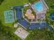 Overhead view of community amenities showcasing a pool, playground, parking, and sports courts at 3629 Bellmeade Ct, Wesley Chapel, FL 33543
