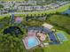 Aerial view shows community pool, clubhouse, sports courts, and playground near homes at 3629 Bellmeade Ct, Wesley Chapel, FL 33543