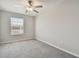 Carpeted bedroom offers natural light and a ceiling fan at 3629 Bellmeade Ct, Wesley Chapel, FL 33543