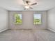 Bright bedroom featuring plush carpeting and a window view at 3629 Bellmeade Ct, Wesley Chapel, FL 33543