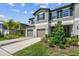 Stylish townhome features a two-car garage, neutral tones, and attractive landscaping at 3629 Bellmeade Ct, Wesley Chapel, FL 33543