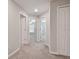 Hallway featuring neutral paint, carpet and closet and bedroom access at 3629 Bellmeade Ct, Wesley Chapel, FL 33543