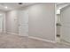 Hallway access to bedroom and bathroom; neutral carpet throughout at 3629 Bellmeade Ct, Wesley Chapel, FL 33543