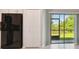 Modern kitchen area with a stainless steel refrigerator, pantry, and sliding glass doors to the backyard at 3629 Bellmeade Ct, Wesley Chapel, FL 33543