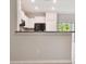 Contemporary kitchen featuring white cabinets, granite countertops, and a breakfast bar area at 3629 Bellmeade Ct, Wesley Chapel, FL 33543