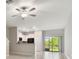 Open-concept living room with tile flooring, a modern kitchen, and sliding glass doors to the backyard at 3629 Bellmeade Ct, Wesley Chapel, FL 33543