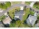 Aerial view of a home with an enclosed pool and lanai in a residential neighborhood at 3994 Belmoor Dr, Palm Harbor, FL 34685