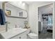 Stylish bathroom featuring a glass bowl sink, decorative mirror, and a view of a home's interior at 3994 Belmoor Dr, Palm Harbor, FL 34685