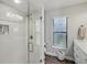 Bathroom featuring a glass enclosed shower, and a double sink vanity with wood look floors at 3994 Belmoor Dr, Palm Harbor, FL 34685