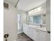Bright bathroom featuring white subway tile in the shower and double sink vanity with framed mirror at 3994 Belmoor Dr, Palm Harbor, FL 34685