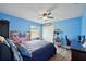 This light blue bedroom has a ceiling fan, and a display of baseball memorabilia at 3994 Belmoor Dr, Palm Harbor, FL 34685