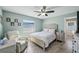 Cozy bedroom with a ceiling fan, sitting chair, and plank floors at 3994 Belmoor Dr, Palm Harbor, FL 34685