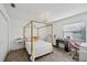 Bedroom featuring a four-poster bed, chandelier, and wood-look floors at 3994 Belmoor Dr, Palm Harbor, FL 34685
