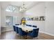 Bright dining area features a large arched window and modern decor and furnishings at 3994 Belmoor Dr, Palm Harbor, FL 34685