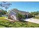Charming home featuring a two-car garage, lovely landscaping, and a basketball hoop at 3994 Belmoor Dr, Palm Harbor, FL 34685