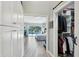Hallway with wood-look floors leading to main bedroom overlooking the pool at 3994 Belmoor Dr, Palm Harbor, FL 34685