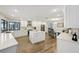 Well-lit kitchen with white cabinets, stainless steel appliances, and an island with counter seating at 3994 Belmoor Dr, Palm Harbor, FL 34685