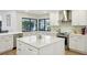 Open kitchen design with custom cabinets, stainless appliances, island, and a lovely window view at 3994 Belmoor Dr, Palm Harbor, FL 34685