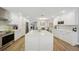 Well-lit kitchen with stainless steel appliances, a central island, and an adjacent dining area at 3994 Belmoor Dr, Palm Harbor, FL 34685