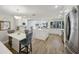 Bright, open kitchen features white cabinetry, stainless steel appliances, and wood-look flooring at 3994 Belmoor Dr, Palm Harbor, FL 34685