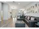 Bright and airy living room with wood flooring, a sectional sofa, and a view of the dining area through glass doors at 3994 Belmoor Dr, Palm Harbor, FL 34685