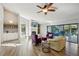 Cozy living room showcasing built-in cabinets, a fireplace, and a serene view of the outdoor pool area at 3994 Belmoor Dr, Palm Harbor, FL 34685