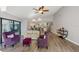 Bright living room featuring vaulted ceilings, wood-look floors, and a seamless flow to the kitchen at 3994 Belmoor Dr, Palm Harbor, FL 34685