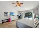 Bright main bedroom featuring a ceiling fan, sliding doors to the pool, and wood-look floors at 3994 Belmoor Dr, Palm Harbor, FL 34685