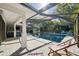 Relaxing pool area with lounge chairs and a screened enclosure providing a serene outdoor retreat at 3994 Belmoor Dr, Palm Harbor, FL 34685