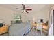 Bright bedroom with a ceiling fan and a work desk, providing a functional and comfortable space for both rest and productivity at 4509 10Th N Ave, St Petersburg, FL 33713
