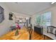Dining area showcasing hardwood floors and a large window, adjacent to an open kitchen concept at 4509 10Th N Ave, St Petersburg, FL 33713