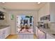 Bright kitchen with white cabinets opens to an outdoor patio with seating at 4509 10Th N Ave, St Petersburg, FL 33713