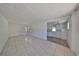 Bright room featuring tiled floors, white paneled walls and partial kitchen view at 4509 10Th N Ave, St Petersburg, FL 33713