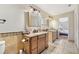 Well-lit bathroom with dual sinks, granite counters, tile flooring and decorative accents at 505 Timber Pond Dr, Brandon, FL 33510