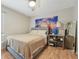 Comfortable bedroom featuring wood floors, neutral walls, and a charming Rapunzel mural at 505 Timber Pond Dr, Brandon, FL 33510