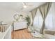 Cozy Bedroom with a crib, dresser, plush chair, and soft, natural light streaming through the windows at 505 Timber Pond Dr, Brandon, FL 33510