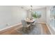 Bright dining room features a modern light fixture, window views, and a light-colored wood table with seating for six at 505 Timber Pond Dr, Brandon, FL 33510