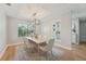 Elegant dining room with modern chandelier, natural light, and seating for six around a wooden table at 505 Timber Pond Dr, Brandon, FL 33510