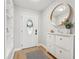 Inviting entryway featuring an oval-window door, built-in shelving, and modern storage cabinet at 505 Timber Pond Dr, Brandon, FL 33510