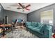 Modern living room featuring dark walls, a comfortable couch, and a dedicated gaming setup at 505 Timber Pond Dr, Brandon, FL 33510